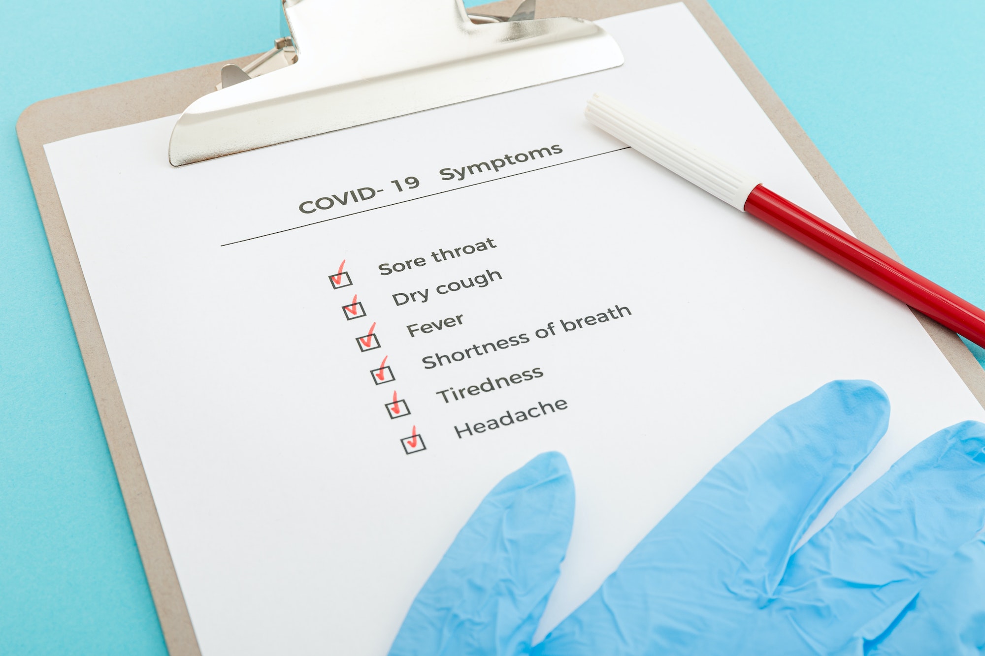 Checklist On Clipboard COVID-19 symptoms concept