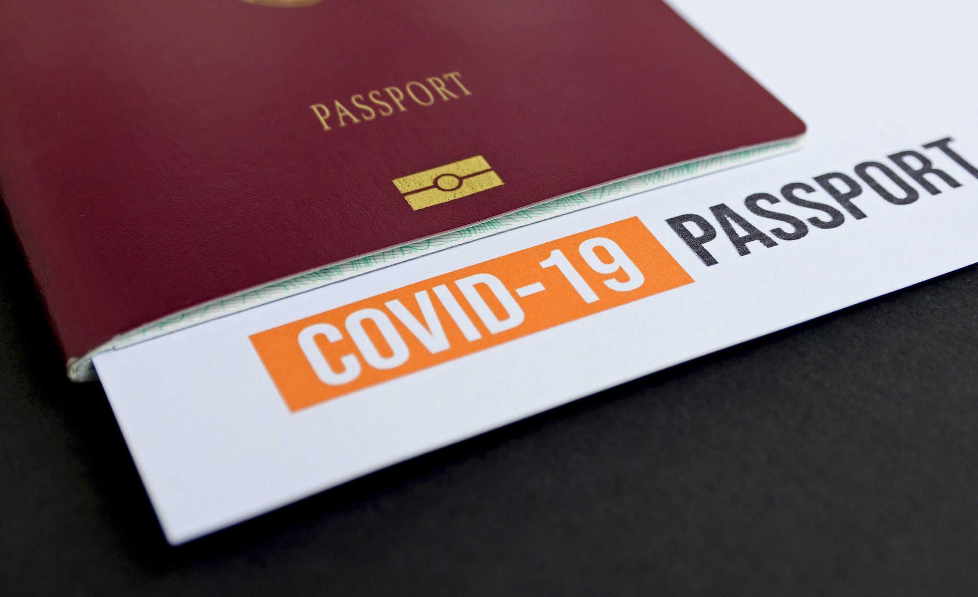 Close-up image of passport with covid test report.