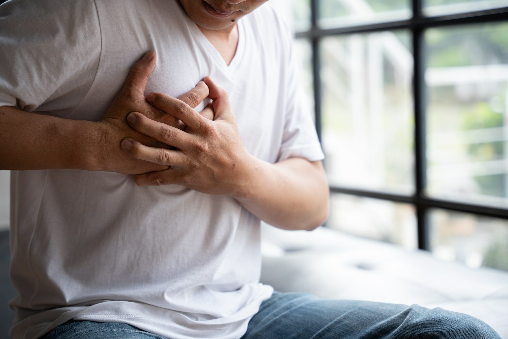 Hands holding chest with symptom heart attack disease, Man With Heart Attack.