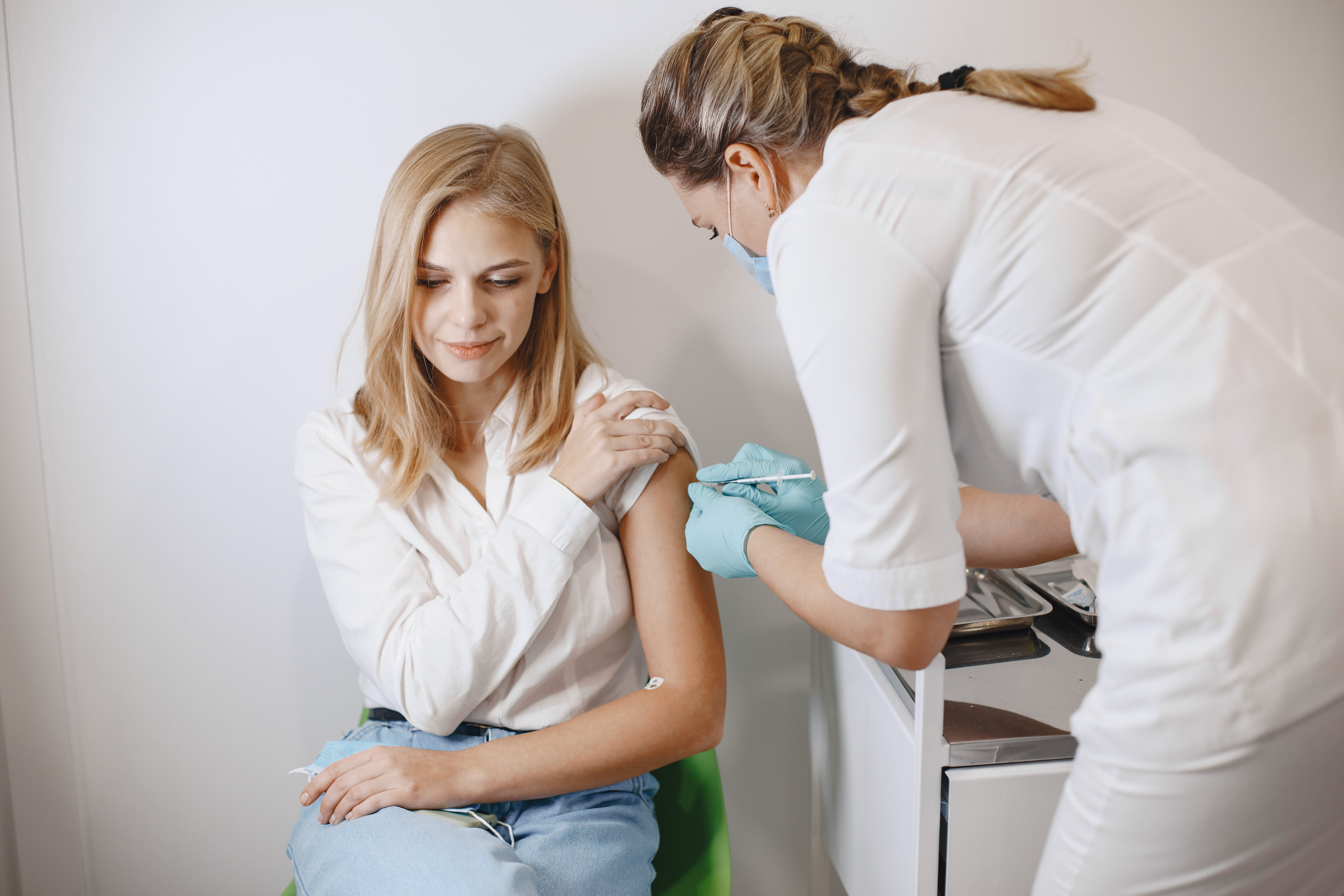 Woman doctor gives a vaccine to patients